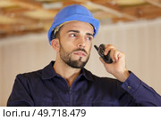 engineer or worker is using radio isolated on white background. Стоковое фото, агентство Ingram Publishing / Фотобанк Лори