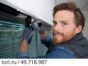 man grinding window surface with electric grinder. Стоковое фото, агентство Ingram Publishing / Фотобанк Лори