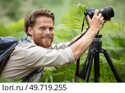 a videographer documenting a sunset on the beach. Стоковое фото, агентство Ingram Publishing / Фотобанк Лори