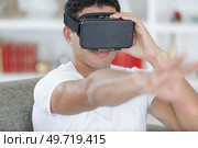 young handsome man in a virtual reality mask. Стоковое фото, агентство Ingram Publishing / Фотобанк Лори