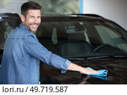 man taking care and cleaning his new car. Стоковое фото, агентство Ingram Publishing / Фотобанк Лори