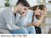 disappointed couple holding a pregnancy test. Стоковое фото, агентство Ingram Publishing / Фотобанк Лори