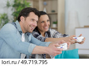 excited male and female hipsters rejoice in winning a video-game. Стоковое фото, агентство Ingram Publishing / Фотобанк Лори