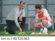 coach talking tactics with young foorball palyer. Стоковое фото, агентство Ingram Publishing / Фотобанк Лори