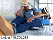 tourist napping on a bench with baggage at the station. Стоковое фото, агентство Ingram Publishing / Фотобанк Лори