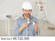 a man holding cable plugs. Стоковое фото, агентство Ingram Publishing / Фотобанк Лори