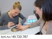 she is cleaning the fingernails. Стоковое фото, агентство Ingram Publishing / Фотобанк Лори