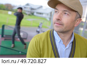 man training at a mini golf. Стоковое фото, агентство Ingram Publishing / Фотобанк Лори