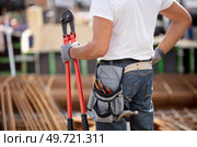 construction site worker wearing velt with tools. Стоковое фото, агентство Ingram Publishing / Фотобанк Лори
