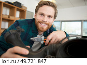 young bearded man holds and pliers. Стоковое фото, агентство Ingram Publishing / Фотобанк Лори