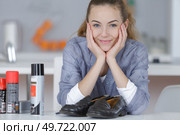 happy young woman after polishing her shoes. Стоковое фото, агентство Ingram Publishing / Фотобанк Лори