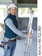 male builder holding a stepladder. Стоковое фото, агентство Ingram Publishing / Фотобанк Лори