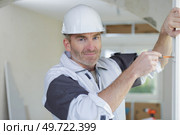 portrait of builder during installation of window. Стоковое фото, агентство Ingram Publishing / Фотобанк Лори