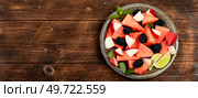 Fresh juicy salad of watermelon, blackberry and peach. Summer fruit diet salad on old wooden table. Recipe placewith copy space.. Fruity summer watermelon salad, space for text. Стоковое фото, агентство Ingram Publishing / Фотобанк Лори