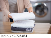 cropped photo of woman stacking clean towels. Стоковое фото, агентство Ingram Publishing / Фотобанк Лори