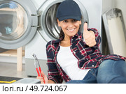 young plumber woman smiling broadly showing thumbs up. Стоковое фото, агентство Ingram Publishing / Фотобанк Лори