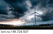 Dark shelf cloud preceding a severe thunderstorm at a wind turbine park. Beautiful thunderstorm black clouds and clouds hanging over the ground. Стоковое AI-изображение, AI-художник ALLA YURTAYEVA / Фотобанк Лори