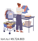 Housewife doing housework hangs washed clothes on hanger. Woman decluttering and organizing wardrobe, putting clothes into Sale and Trash boxes. Person taking inventory and sorting out apparels. Housewife doing housework hangs washed clothes on hanger. Woman decluttering and organizing wardrobe. Стоковая иллюстрация, агентство Ingram Publishing / Фотобанк Лори