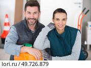 two workers leaning on plastic container in factory. Стоковое фото, агентство Ingram Publishing / Фотобанк Лори