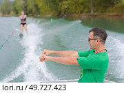water ski coach giving advise to his student. Стоковое фото, агентство Ingram Publishing / Фотобанк Лори
