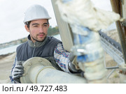 pipe fitter checking the connections. Стоковое фото, агентство Ingram Publishing / Фотобанк Лори