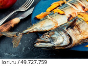 Two appetizing mackerel fish roasted with mango. Baked mackerel with mango, scomber roast. Стоковое фото, агентство Ingram Publishing / Фотобанк Лори