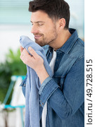 young man husband doing clothing ironing at home. Стоковое фото, агентство Ingram Publishing / Фотобанк Лори