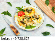 Appetizing nests of noodles with meatballs and nettles. Casserole.. Nest of noodle with meatballs, keto dish. Стоковое фото, агентство Ingram Publishing / Фотобанк Лори