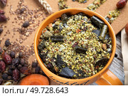 special muesli and granules for senior horses  served in bowl around muesli background.  feeding and horse care concept. Стоковое фото, агентство Ingram Publishing / Фотобанк Лори