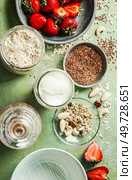 Healthy vegan breakfast ingredients, coconut yogurt, oat-flakes, nuts, linseed and berries , top view. Стоковое фото, агентство Ingram Publishing / Фотобанк Лори
