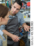 shoemaker with female apprentice at work. Стоковое фото, агентство Ingram Publishing / Фотобанк Лори