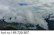 Aerial view of snowcapped mountains in clouds. Стоковое фото, фотограф Михаил Коханчиков / Фотобанк Лори