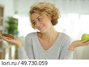 trying to choose between good and bad food. Стоковое фото, агентство Ingram Publishing / Фотобанк Лори
