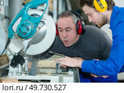 carpentry teacher blowing the dust off. Стоковое фото, агентство Ingram Publishing / Фотобанк Лори