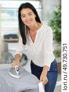 mature lady doing the ironing. Стоковое фото, агентство Ingram Publishing / Фотобанк Лори