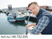 a man is on quayside. Стоковое фото, агентство Ingram Publishing / Фотобанк Лори