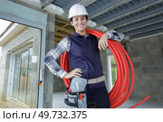 engineer holding pipes in a construction site. Стоковое фото, агентство Ingram Publishing / Фотобанк Лори