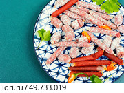 Three varieties of salami sausage on a plate, bratwurst sausage.. Tasty salami on a plate. Стоковое фото, агентство Ingram Publishing / Фотобанк Лори