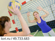 Woman defending handball net from opponent. Стоковое фото, агентство Ingram Publishing / Фотобанк Лори
