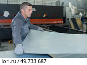 man working at a factory manufacturing tempered clear float glass. Стоковое фото, агентство Ingram Publishing / Фотобанк Лори
