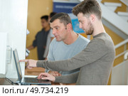 graduate student with student indoors. Стоковое фото, агентство Ingram Publishing / Фотобанк Лори