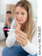 sad unhappy woman looking at pregnancy test at home. Стоковое фото, агентство Ingram Publishing / Фотобанк Лори
