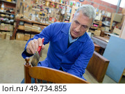 carpenter working on chair part. Стоковое фото, агентство Ingram Publishing / Фотобанк Лори