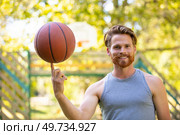 young sports man playing basketball outdoors. Стоковое фото, агентство Ingram Publishing / Фотобанк Лори