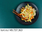 Salad of enoki mushrooms and vegetables served on a black plate. Asia Thai food. Copy space for text.. Vegan salad with enoki mushrooms. Стоковое фото, агентство Ingram Publishing / Фотобанк Лори