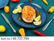 Plate of grilled trout steak with orange sauce. Healthy food with omega.. Grilled salmon steak in orange marinade. Стоковое фото, агентство Ingram Publishing / Фотобанк Лори