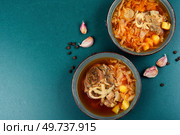 Appetizing borscht or borshch with garlic on the table. Copy space.. Delicious homemade borscht or soup. Стоковое фото, агентство Ingram Publishing / Фотобанк Лори