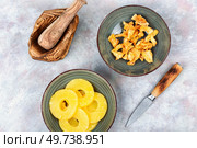Heap dried pineapples or ananas in bowls. Candy pineapples.. Dried pineapple food snacks. Стоковое фото, агентство Ingram Publishing / Фотобанк Лори