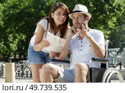 disabled man and girlfriend tourists consulting map of city. Стоковое фото, агентство Ingram Publishing / Фотобанк Лори