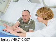 doctor examining the patients hands. Стоковое фото, агентство Ingram Publishing / Фотобанк Лори
